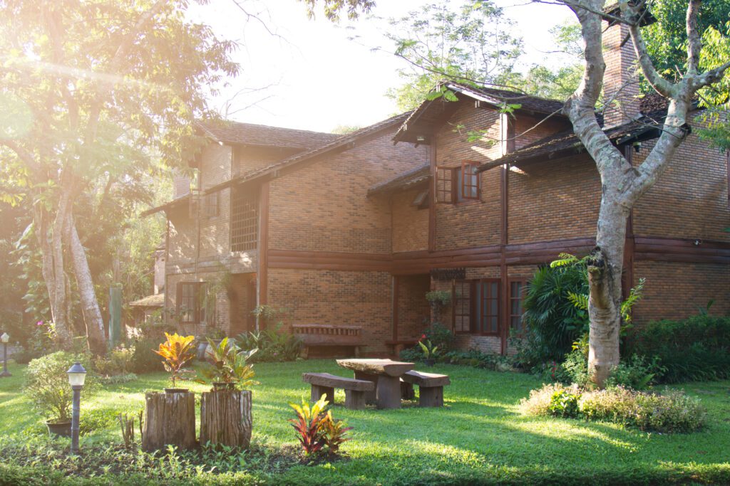 House build brick and wood in countryside. soft flare sunlight.