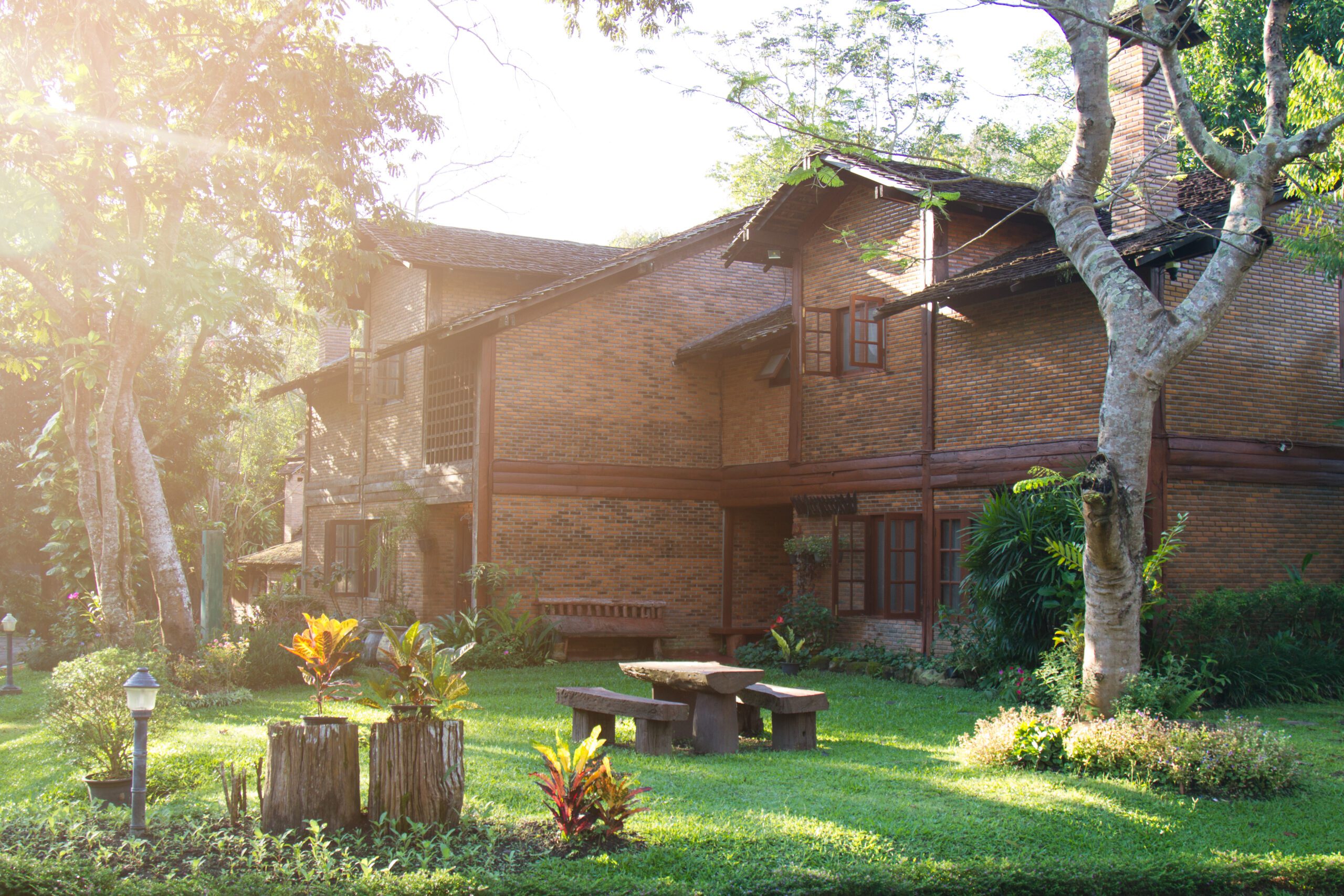 House build brick and wood in countryside. soft flare sunlight.